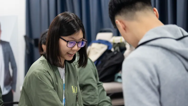 Two participants in conversation during an activity
