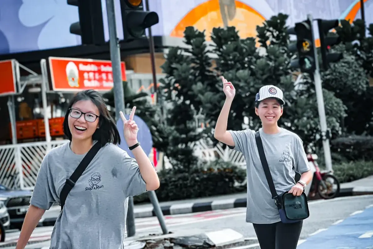Two colleagues celebrating together during an outdoor team activity